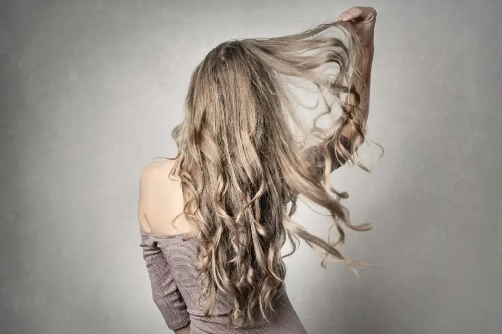 A woman pulling her long hair